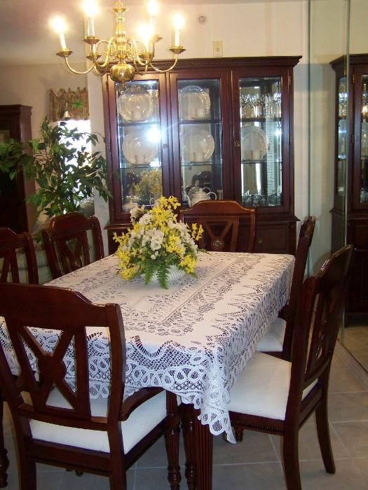 Dining room table with extra leaf, six chairs, lighted china cabinet with mirrored back.  