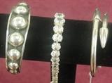 Selection from sterling bracelets-heavy Mexican cuff with rivet look and niello, graduated oval CZ line bracelet,  sleek Mexican hinged cuff with cone/bullet terminals. 