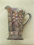 Northwood carnival glass milk pitcher in purple/amethyst. 