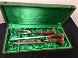 
Anton Wingen Jr Solingen Germany Stag Knives.  Stainless steel blade with superb wild life etched design and Antler handles. Included carving knife, carving fork and knife sharpener. Solingen Germany Rostfrei Othello. Excellent vintage condition in the original box. 