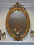 INVENTORY NO. 76 1900 CENTURY OVAL MIRROR WITH OPEN WORK SCROLL CREST.