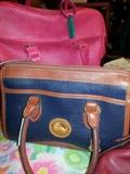 Dooney & Bourke All Weather satchel (front) and hot pink Samsonite travel bag