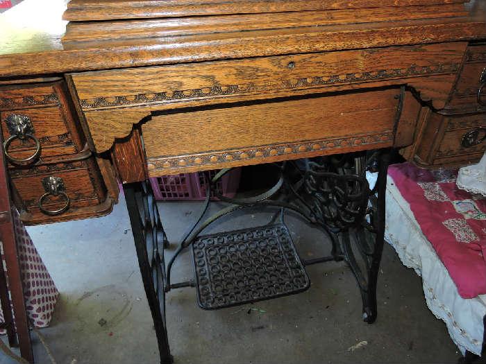 Treadle sewing machine with cabinet.