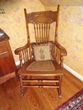 A rocking chair and throw pillow