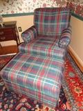 A plaid chair and matching ottoman