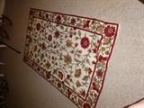 A small floral throw rug with a beautiful floral pattern.