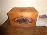 A small wooden chest with ducks on it.