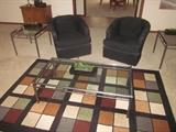 Glass top table with brush nickel, matching end tables. Black swivel barrel chairs, 