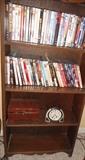 Several bookcases, loaded with paperbacks and hardback books, clocks, accessories,