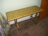 Wrought iron bench with (covered) wood top.