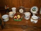 Crystal clock (center) and vintage German and Austrian souvenir porcelain cups.