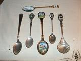 Vintage souvenir spoons, including enameled and sterling.
