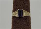 Here is an interesting antique ring (circa 1910). When the ring came in from an estate, the original glass stone was badly damaged, and not usable. We furnished a new genuine amethyst (purple quartz), had our bench jeweler set it into the ring, and completely clean, polish and refinish the ring. Result: a genuine antique ring in superb condition with a brand new genuine stone center. Note the heart design on the shank. The amethyst center is an emerald cut. Ring size of 5.