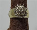 Set with 21 round diamonds, this ring has an estimated diamond weight of 3/8 of a carat. It is made in 10 karat yellow gold, and weighs 6.9 grams. These diamonds are brownish in color – the popular phrase is chocolate diamonds, but this ring was NOT made by LeVian. Still, it's a heavy weight piece with decent diamond weight in an impressive cluster design, circa 1990.