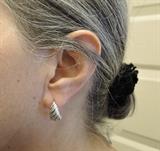 Here is a lovely pair of sterling silver J-hoop earrings. We make these earrings ourselves, from the wax model, to casting and finishing, all by hand, right here in Texas. As they are cast pieces, not lightweight stamped earrings, there is a nice weight to them (but not too much). An interesting feature about these earrings is that there is a right hand earring and a left hand earring; note the way the fluting is done.