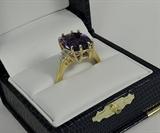 Pictured is a new one-of-a-kind ring that we recently made. Set in the center of the ring is one rectangular cushion genuine amethyst with checkerboard top, and with an exact weight of 5.22 carats. The amethyst has a fine dark purple (and desireable) color. The ring is also set with four fine quality baguette diamonds, and the entire ring is made in 18 karat yellow gold. Note the double prongs on the amethyst. Size six.