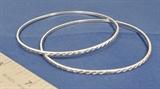 These two matching bangles were made in Mexico; they have an attractive rope design all the way around the bracelet. We note a weight for the pair of 12.9 grams, and they are made in sterling silver. These are vintage bracelets; we estimate that they were made circa 1960.