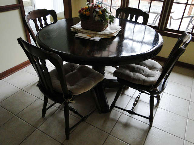 Solid wood pedestal table / 4 chairs. $ 200.00