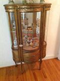Vintage curved glass curio $ 440.00 - 36" wide x 14" deep x 58" tall.  Metal trim loose on front base of glass door.