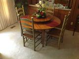 Solid wood round table with built in lazy susan / 4 ladderback chairs $ 400.00 - 52" wide x 28" tall.