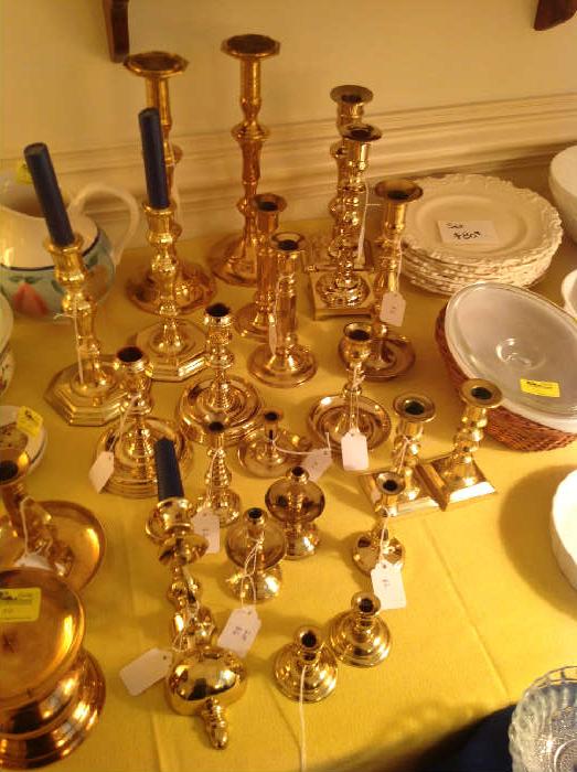 Loads of brass candle holders of all sizes.