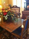       Antique oak draw-leaf table and one of many floral arrangements