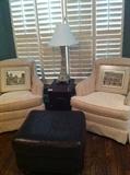 Two matching white chairs; ottoman; side table; lamp