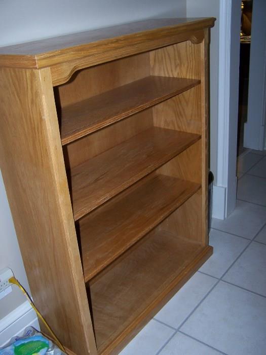 One of two matching wood bookshelves