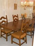 Dining table shown with 2 leaves added