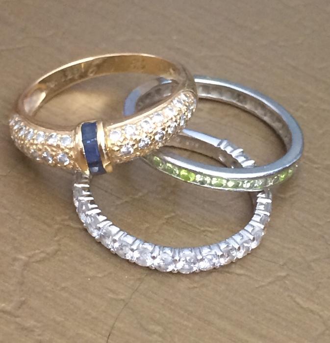 Diamond eternity bands and a diamond and blue sapphire ring
