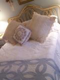 Bed with frame, headboard , pillows and bedding.
