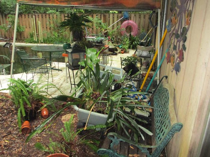 Garden bench, wrought iron, potted plants, stands, ornaments, bird feeders, garden cart