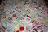 There are several antique hand stitched quilts