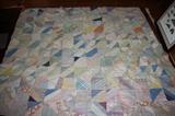 There are several antique hand stitched quilts
