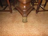 Gilt Lion's Claw feet of the Regency Dining Table