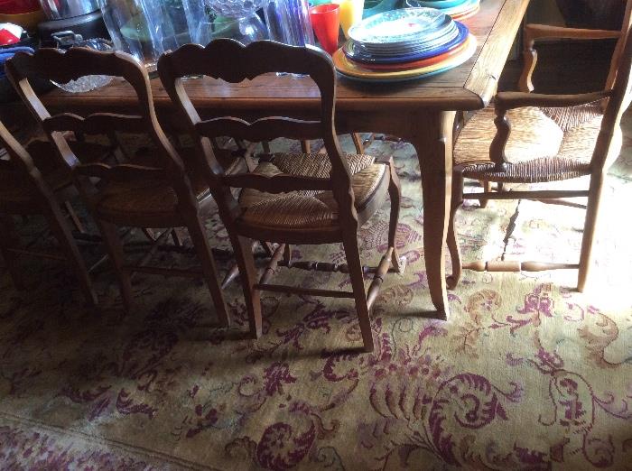 Love this rug! Country French dining table and chairs with reed or rush seats. 