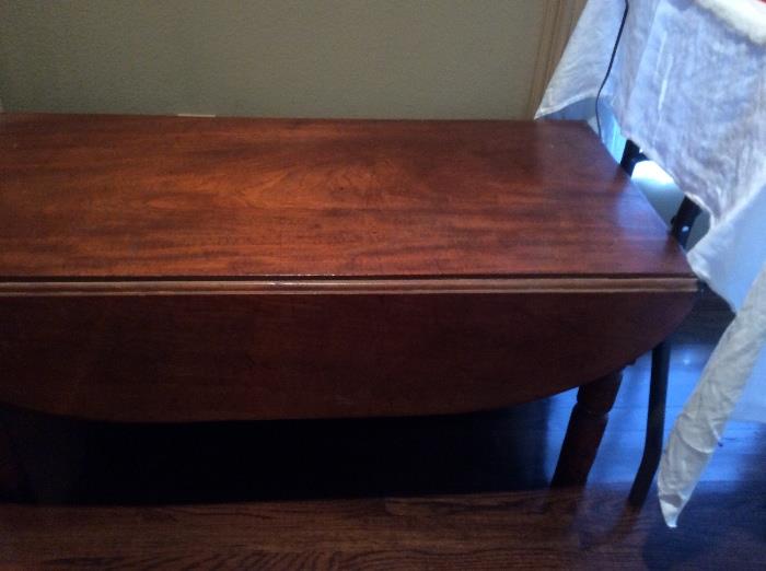 Drop leaf table, very nice but someone shortened the legs to coffee table height. 