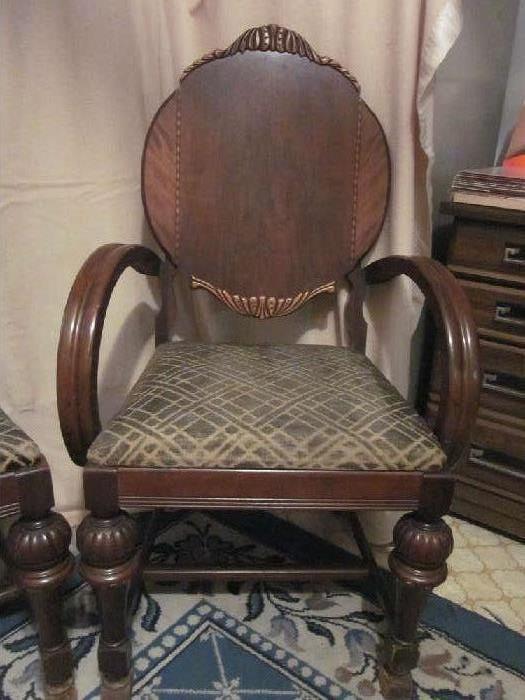 Antique "gentleman's" parlor chair, solid mahogany, carved and inlaid detail on back.