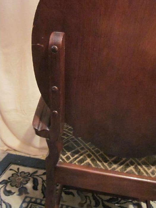 Antique "gentleman's" parlor chair, solid mahogany, carved and inlaid detail on back.