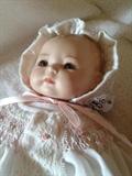 up close of the bisque christening doll
