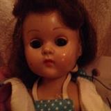 Up close of the vogue doll on the polka dotted romper