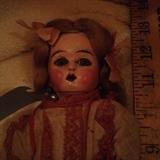 up close of the composite doll with glass eyes