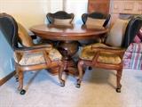 Thomasville dining table with four leather back chairs.