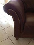 Nail head detail on the leather loveseat