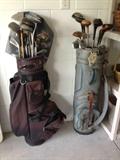Two sets of golf clubs