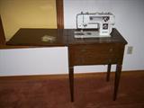 Sewing machine and cabinet