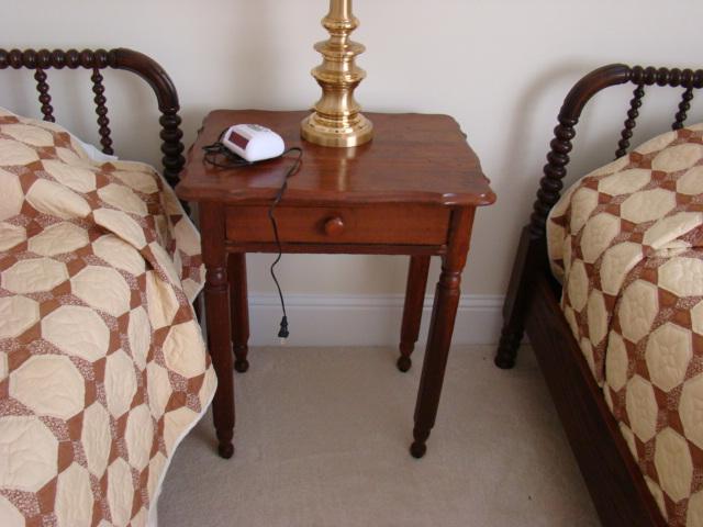 walnut one drawer lamp table with pair of turned spindle single beds