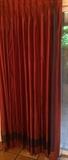 Terra cotta silk draperies with aubergine trim