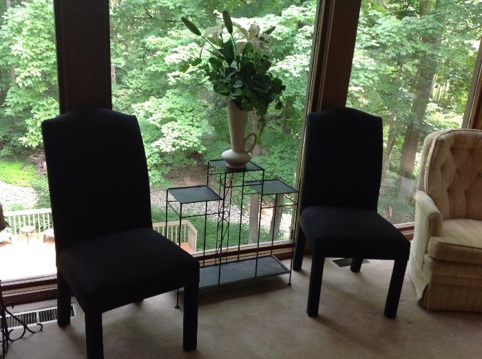 there are four of these black cloth side or dining chairs, nice three-tier glass and metal stand