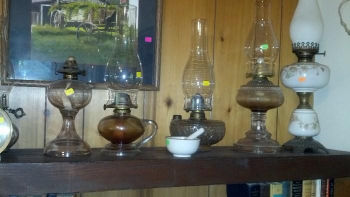 Vintage to antique working oil lamps ( the electric ones are on the other end of the shelf )